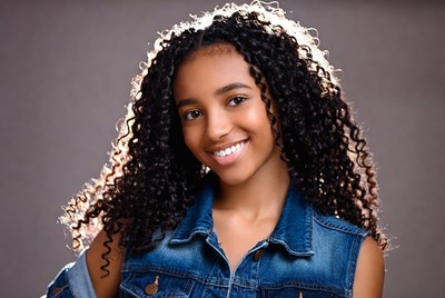 Smiling African-American girl in denim vest