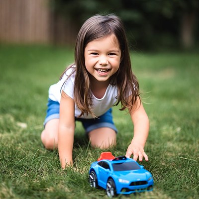 Girl playing with toy car outdoors