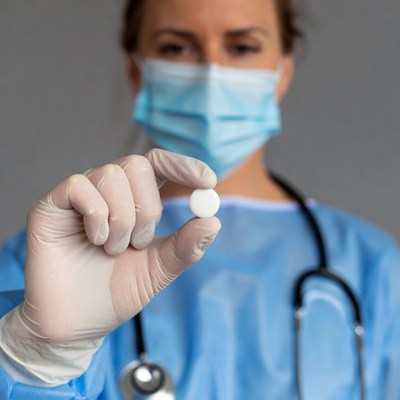 Nurse holding pill in glove