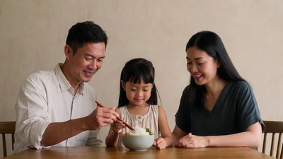 Asian family eating rice with chopsticks