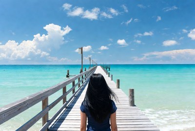 Woman walking on beach pier
