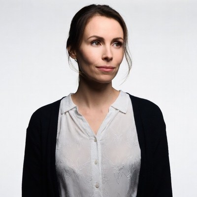 Woman in white blouse and black cardigan