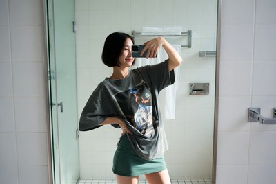 Asian woman taking bathroom selfie