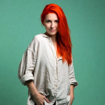 Woman with red hair in white shirt