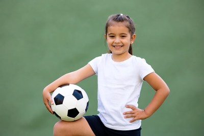 Girl holding soccer ball