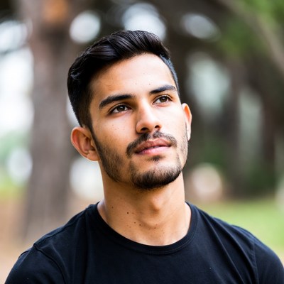 Young Latino man looking up outdoors