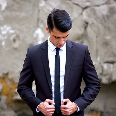 Man adjusting suit jacket