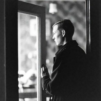 Man gazing through open door