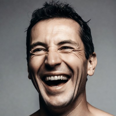 Man laughing with wide smile