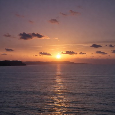 Sunset over ocean with cliffs