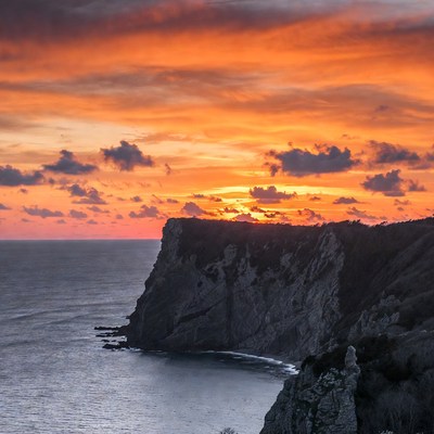 Sunset over ocean cliffs