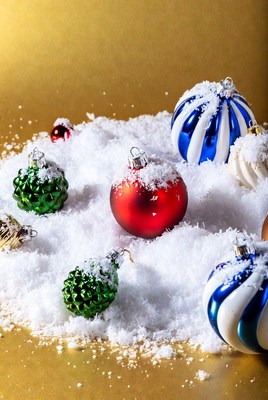 Christmas Ornaments on Snowy Gold Background