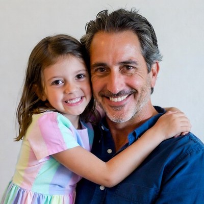 Father hugging smiling daughter