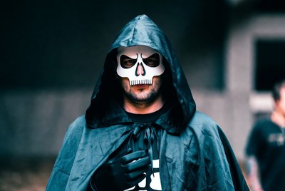 Man in skull mask and hooded cloak