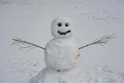 Snowman with stick arms in snow