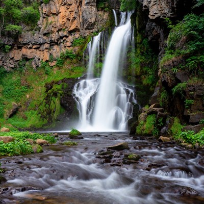 Majestic waterfall cascading over mossy rocks