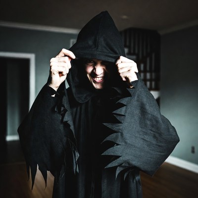 Person in Grim Reaper costume grinning