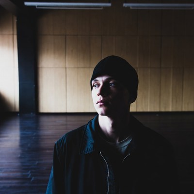 Young man in beanie gazing thoughtfully