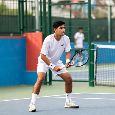 Young man playing tennis on court