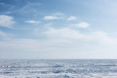 Icy ocean under cloudy sky