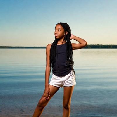 African-American girl posing by lake