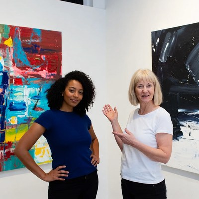Two women standing in art gallery