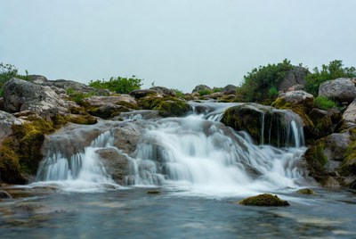 Small waterfall cascading over mossy rocks