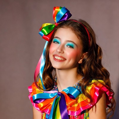 Girl in rainbow bow costume