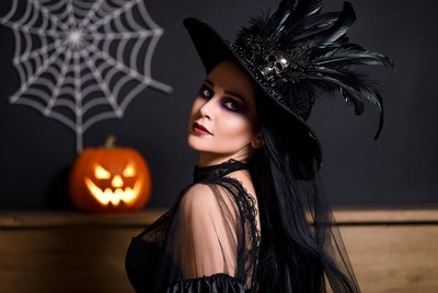 Woman in Witch Hat with Pumpkin
