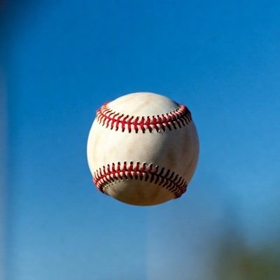 Baseball floating against blue sky