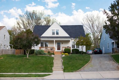 White house with porch and driveway