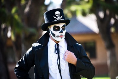 Man in skull face paint and top hat