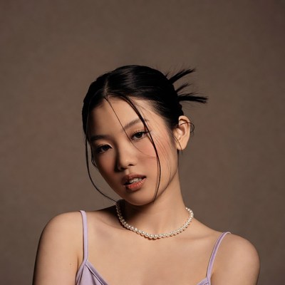 Asian woman in pink slip necklace