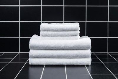 Stacked White Towels on Black Tiles