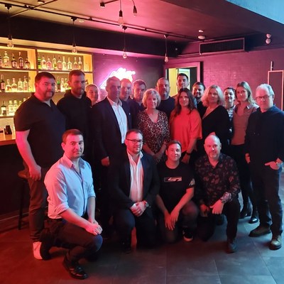 Group of people posing at neon bar