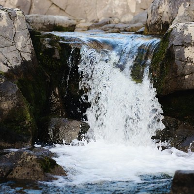 Small waterfall cascading over mossy rocks