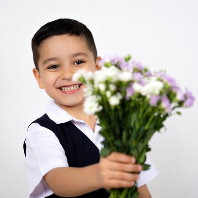 Boy holding white purple flowers