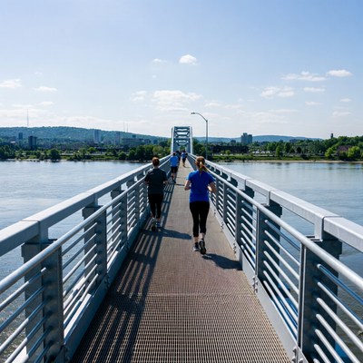 Runners on bridge over river