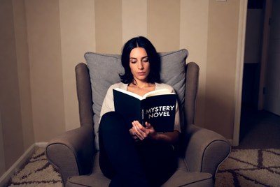 Woman reading mystery novel