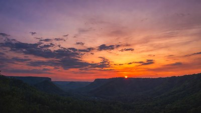 Sunset over forested canyon
