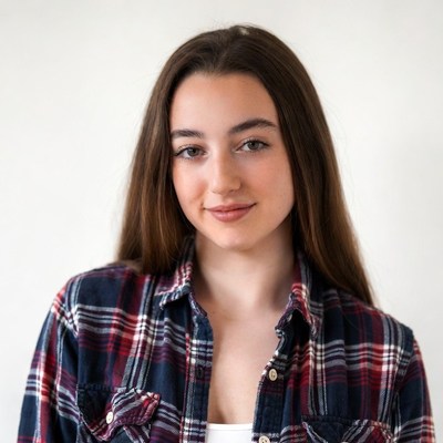 Teen girl in plaid shirt smiling