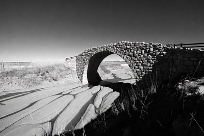 Stone Arch Bridge over Sandy Beach