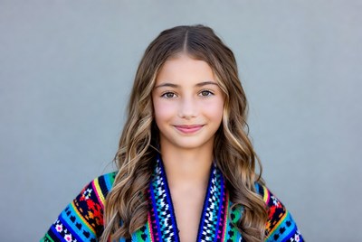 Girl in colorful poncho smiling