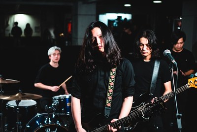 Asian rock band performing on stage