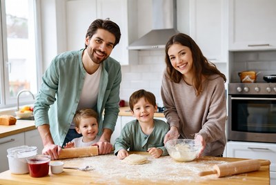 Family baking dough together in kitchen