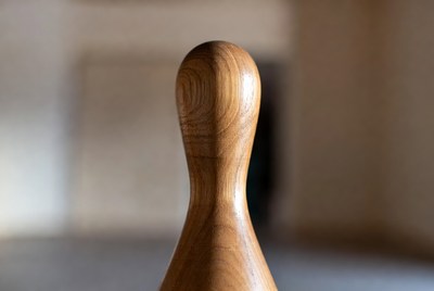 Wooden spindle on blurred background
