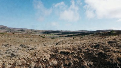 Dry grassy valley under blue sky
