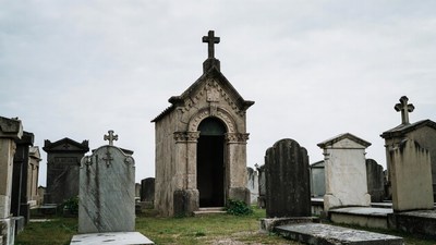 Stone Mausoleum with Cross in Cemetery