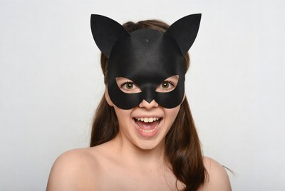 Girl wearing black cat mask