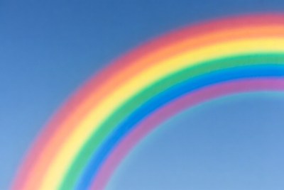 Vibrant Rainbow in Blue Sky